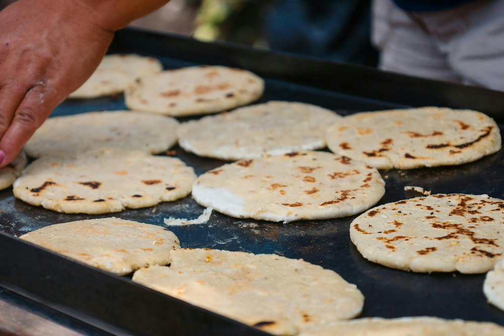 Stock photo of pupusas cooking on a griddle